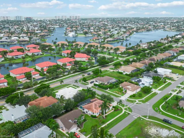 Birds eye view of property with a water view
