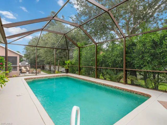 View of pool with a patio area and a lanai