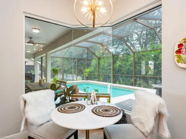 Sunroom featuring an inviting chandelier