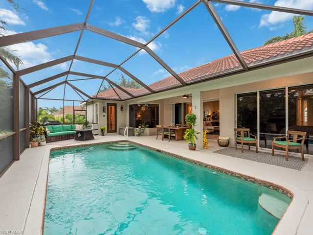 View of swimming pool featuring an outdoor living space, a patio, and glass enclosure