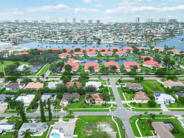 Birds eye view of property with a water view