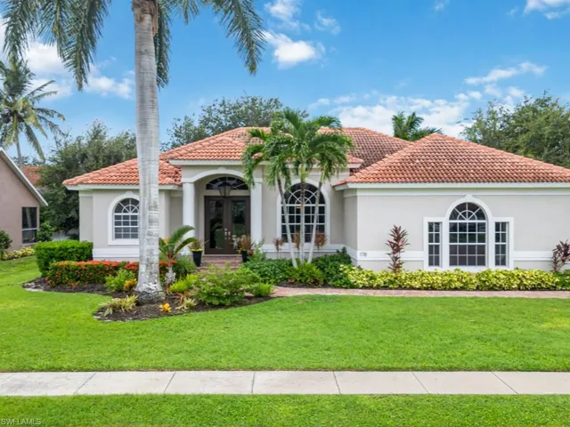 Mediterranean / spanish-style house with french doors and a front yard