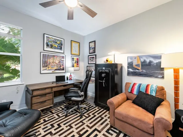 Office area with plenty of natural light, dark hardwood / wood-style floors, and ceiling fan