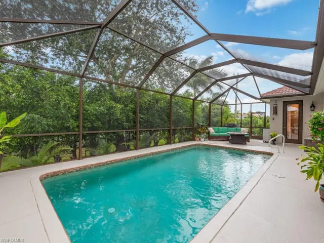 View of swimming pool featuring a patio, an outdoor living space, and a lanai