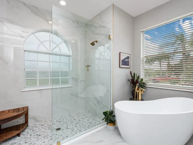 Bathroom with tile patterned floors and separate shower and tub