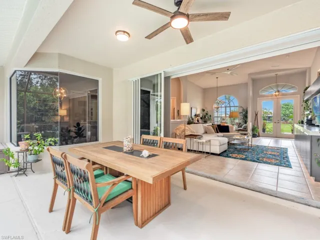 Tiled dining area featuring french doors and ceiling fan