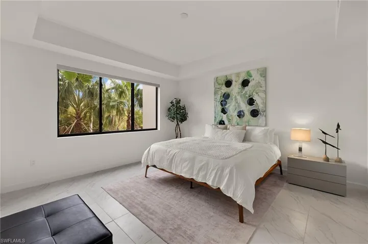 Bedroom featuring a raised ceiling