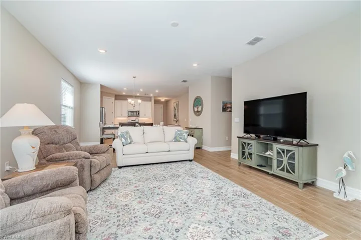 Living room featuring an inviting chandelier and light hardwood / wood-style floors