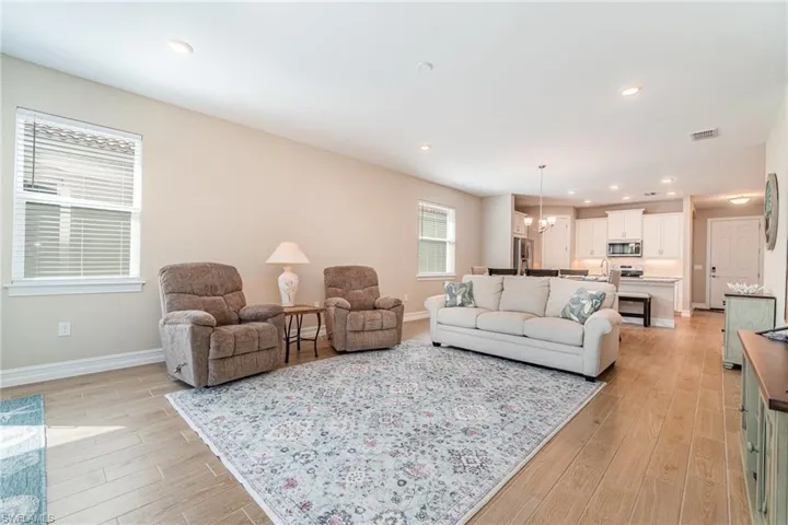 Living room featuring an inviting chandelier and light wood-type flooring