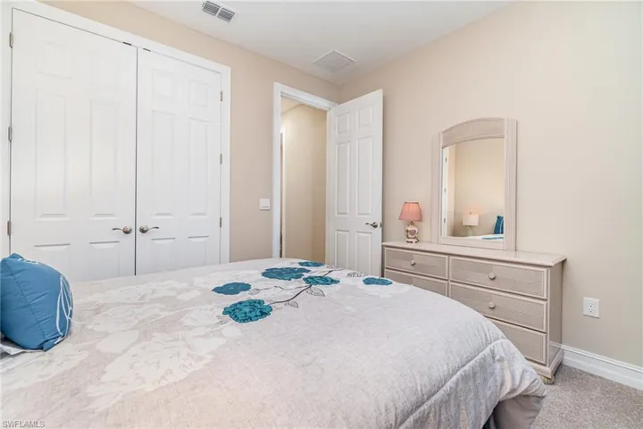 Carpeted bedroom with a closet