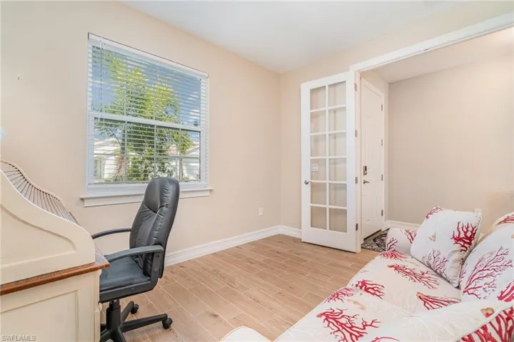Office area featuring french doors and light wood-type flooring