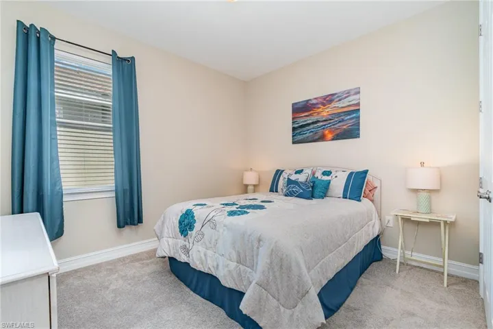 Bedroom featuring light carpet
