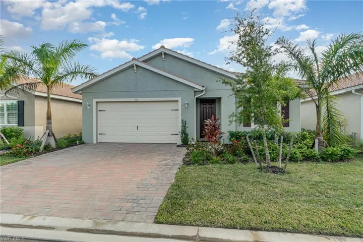 View of front of home featuring a garage and a front lawn
