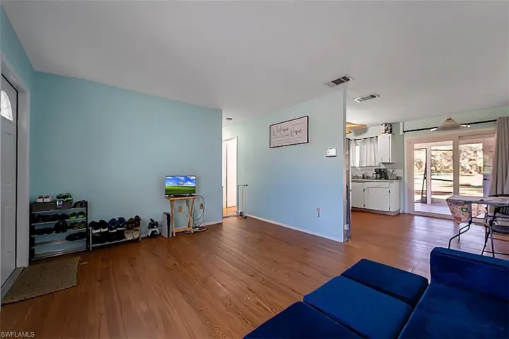 Living area with healthy amount of natural light and wood finished floors