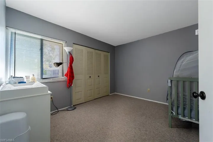 Bedroom featuring a closet and light colored carpet