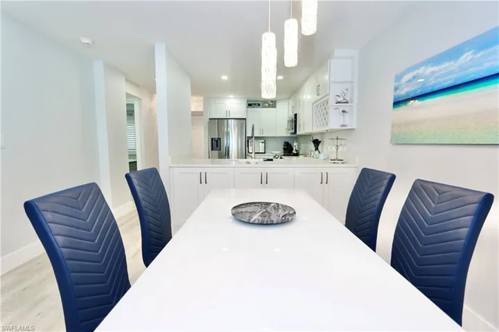 Dining area with light wood-style flooring and baseboards