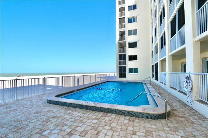 Community Pool featuring a water view and a patio