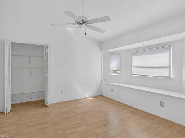 Wood-finish flooring, built-in window seating, and a ceiling fan