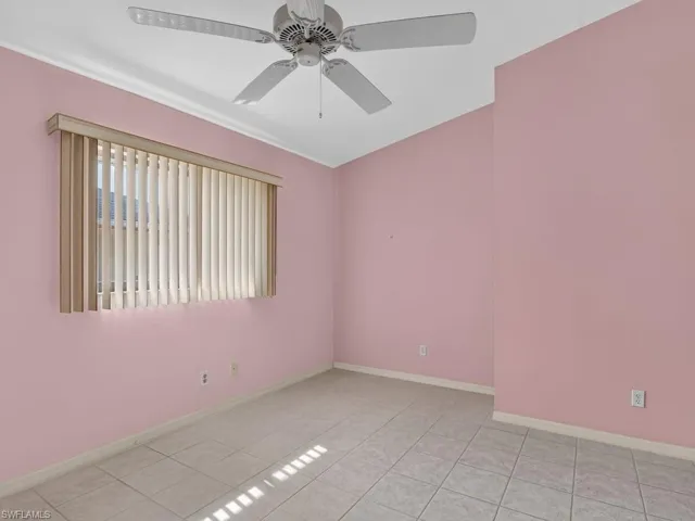 Ceiling fan with light kit, vertical blinds, crown molding, and tiled flooring