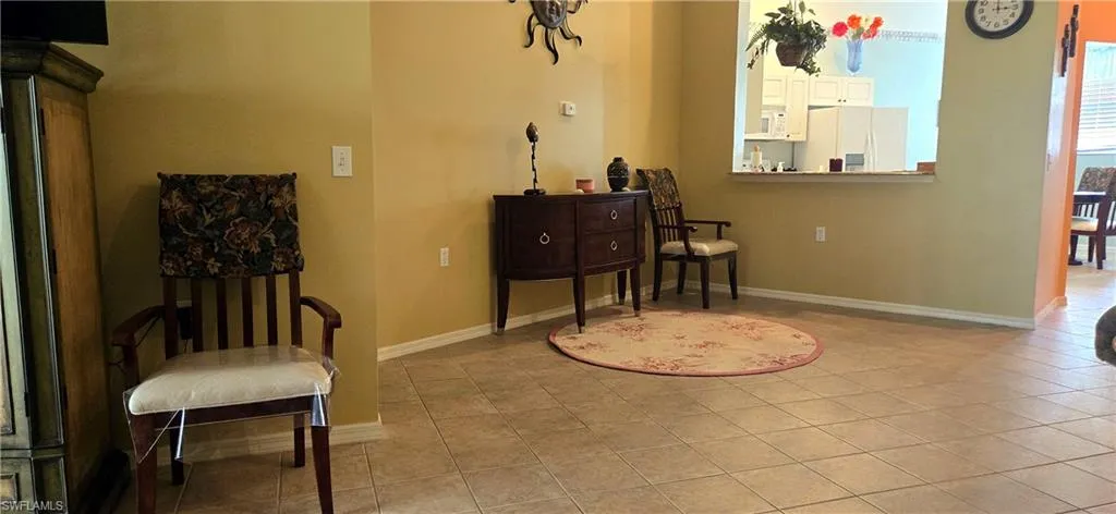 Living area with baseboards and light tile patterned flooring