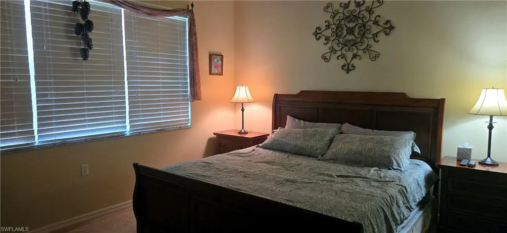 Carpeted bedroom featuring baseboards