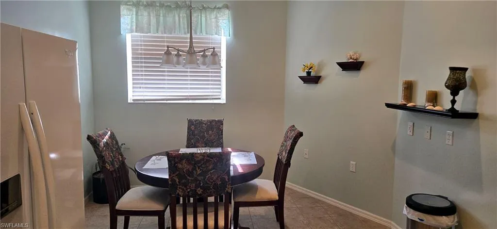 Dining room featuring light tile patterned floors and baseboards