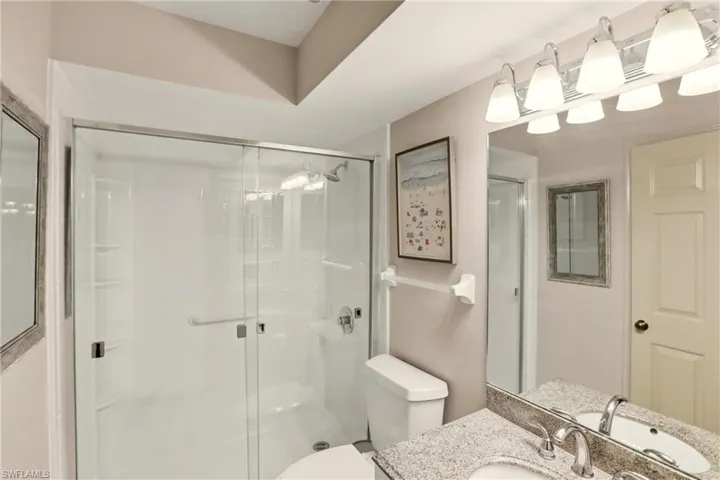 Bathroom featuring a walk-in shower and vanity