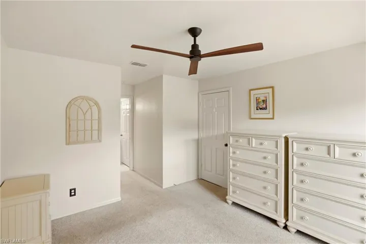 Bedroom featuring light colored carpet and ceiling fan