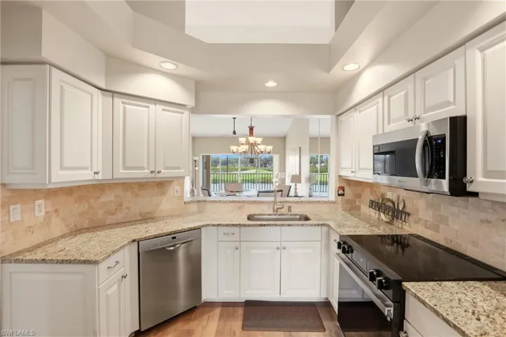 Kitchen with view of great room and lake