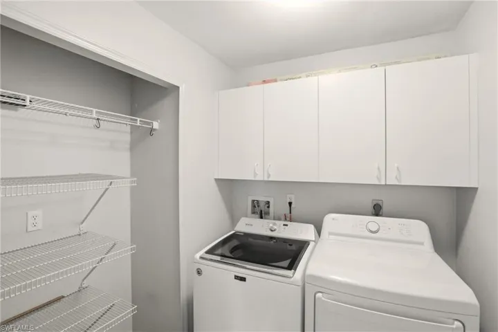 Laundry room features washer, dryer and storage areas