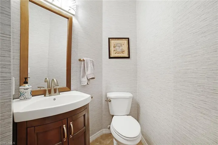 Bathroom with tile patterned floors, toilet, and vanity