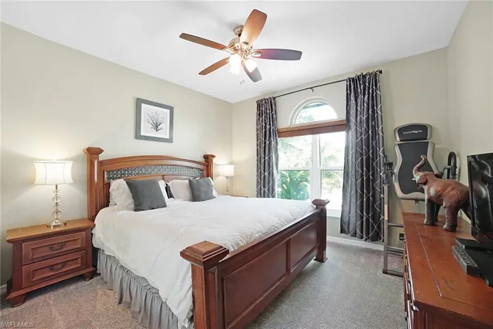Bedroom featuring light colored carpet and ceiling fan