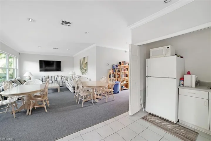 Dining room featuring light tile patterned flooring and crown molding