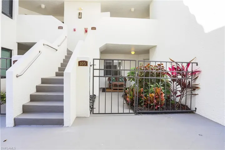 Stairs with finished concrete floors and a high ceiling
