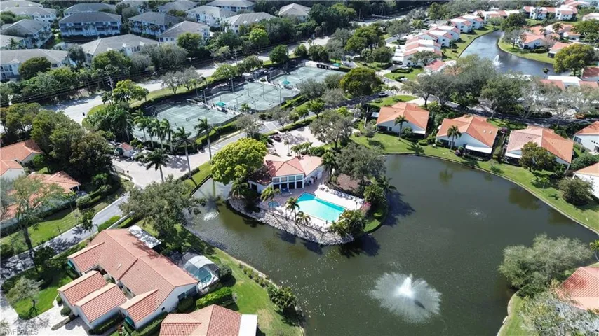Aerial view of property and surrounding area with nearby suburban area and a nearby body of water