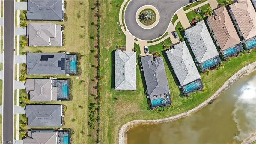 Aerial perspective of suburban area featuring a large body of water