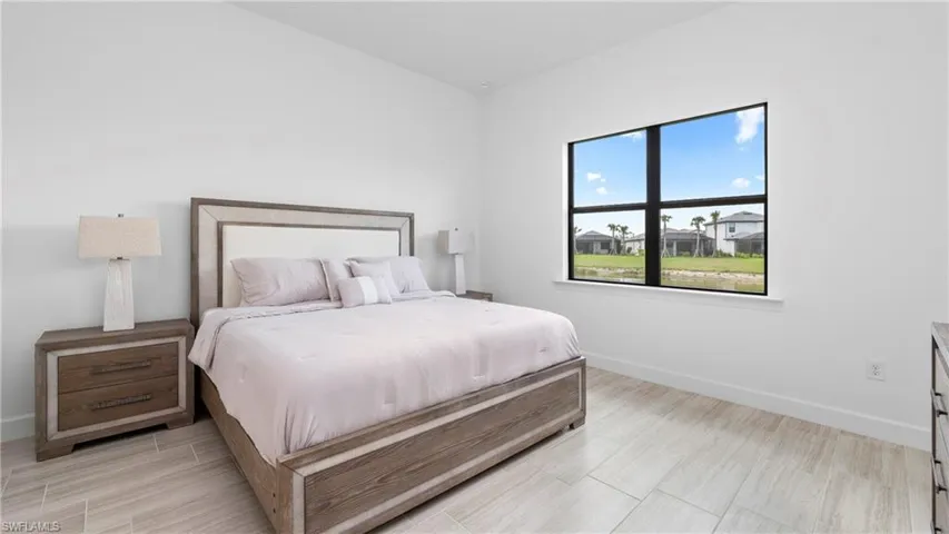 Bedroom featuring baseboards and wood finish floors