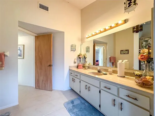 Bathroom featuring tile patterned floors and vanity