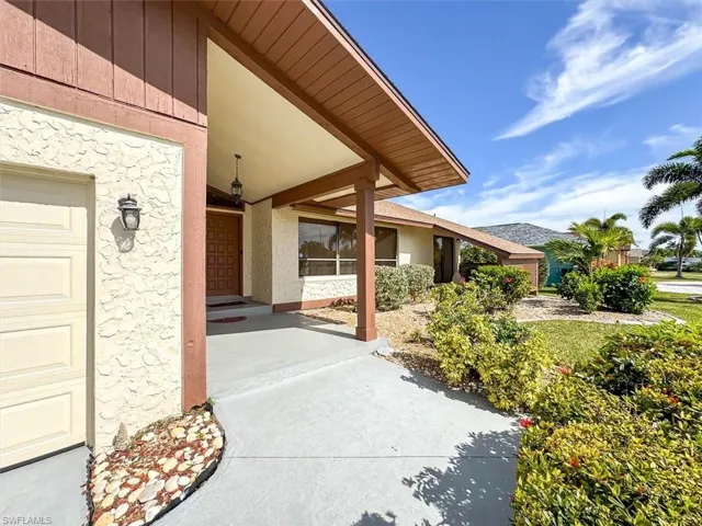 View of exterior entry with a garage