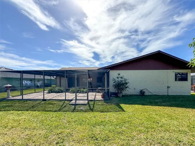 Back of property with a yard and a patio