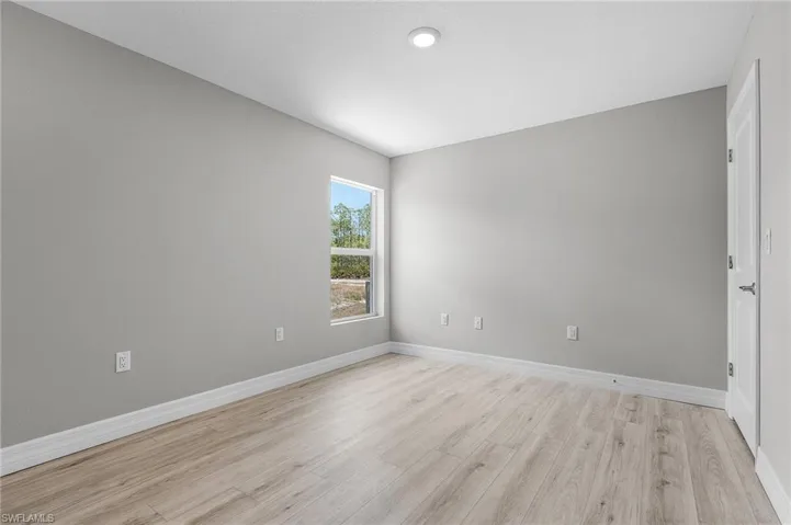 Spare room with light wood finished floors and baseboards