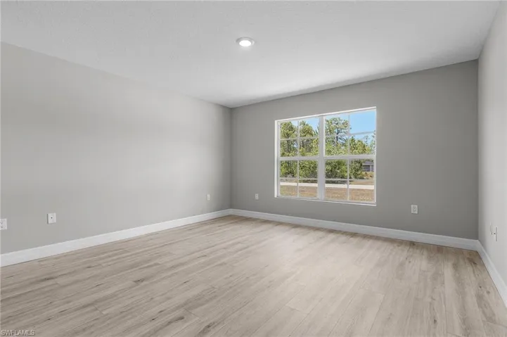 Unfurnished room featuring light wood-style floors and baseboards