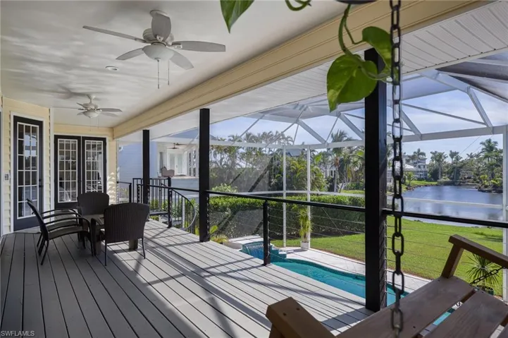Sunroom / solarium featuring a water view