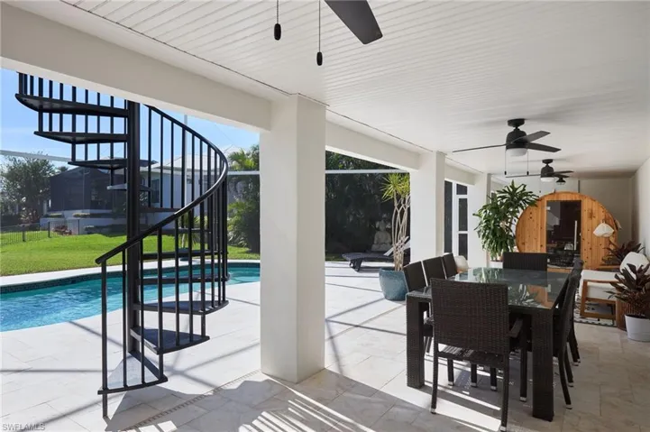 Outdoor pool featuring stairway, a patio area, outdoor dining area, and a lanai