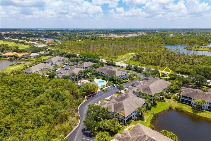 Aerial perspective of suburban area featuring a nearby body of water