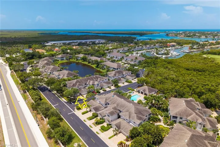 Aerial view of residential area featuring a nearby body of water