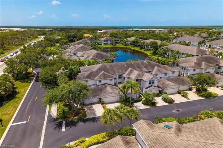 Aerial perspective of suburban area featuring a large body of water