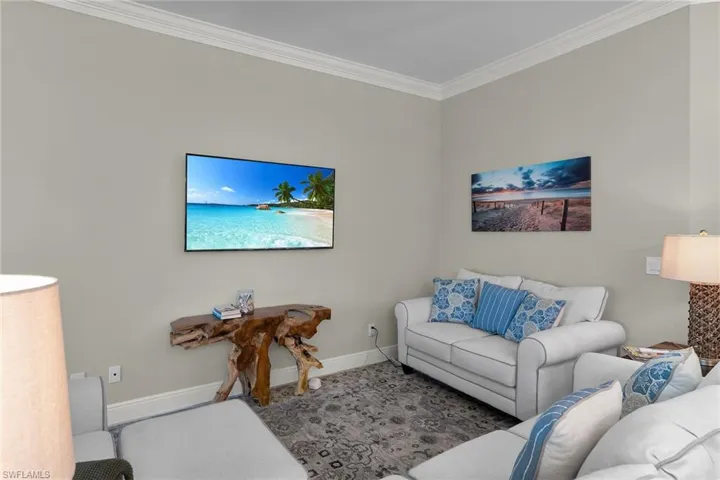 Living room featuring ornamental molding and baseboards