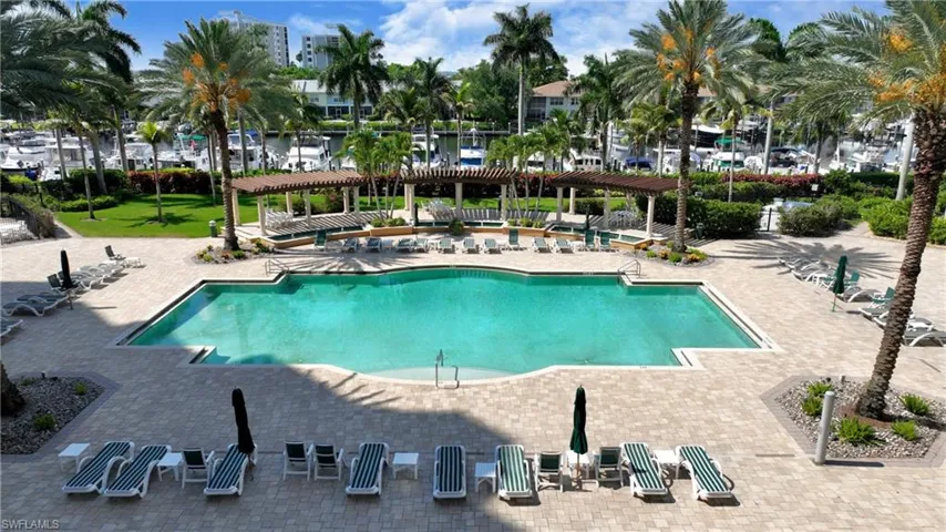 Community pool featuring a pergola, a patio, and a water view