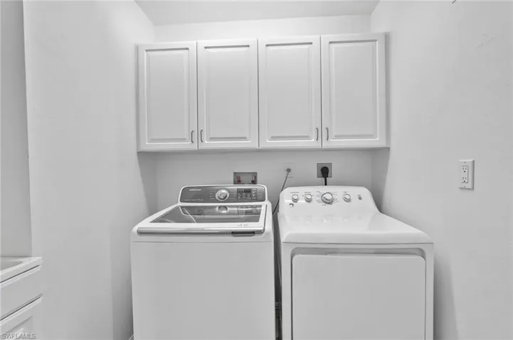 Laundry room featuring cabinet space and washer and dryer